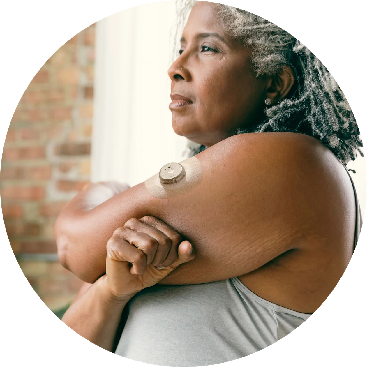 A woman practicing lower body stretches exercise wearing Nutrisense CGM tracking device available in nutrisense.io