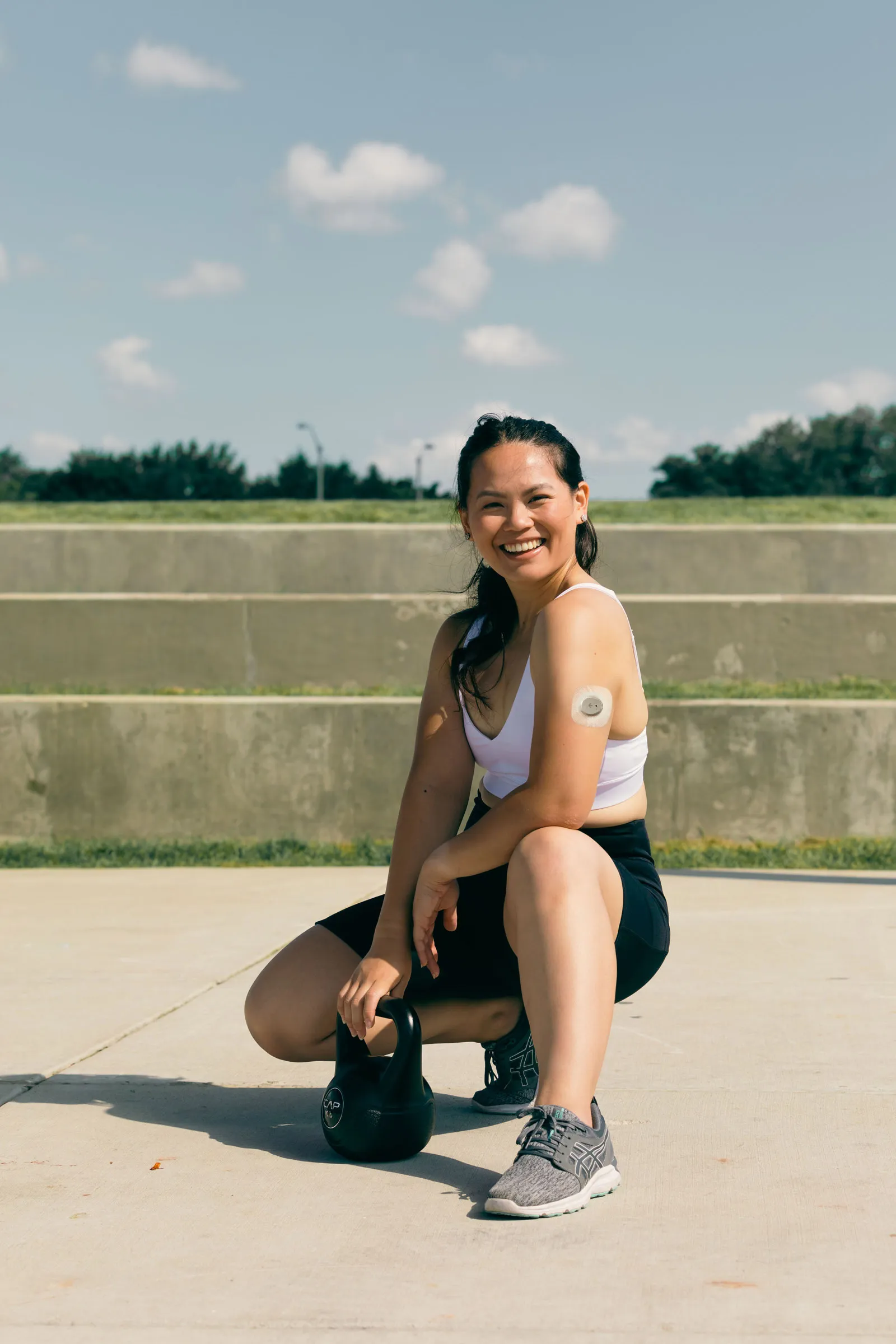 Young woman posing with weights
