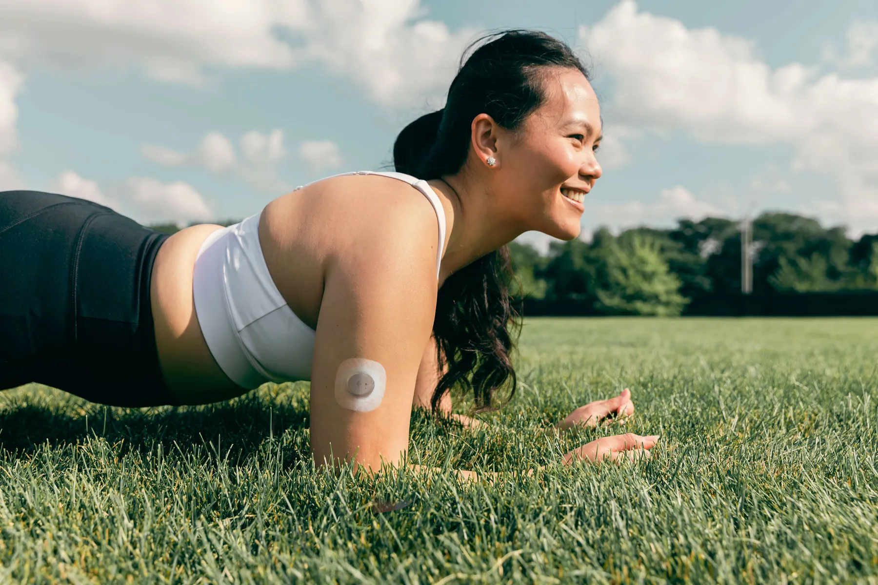 A nutrisense member practicing plunks while wearing a cgm sensor on her upper right hand.