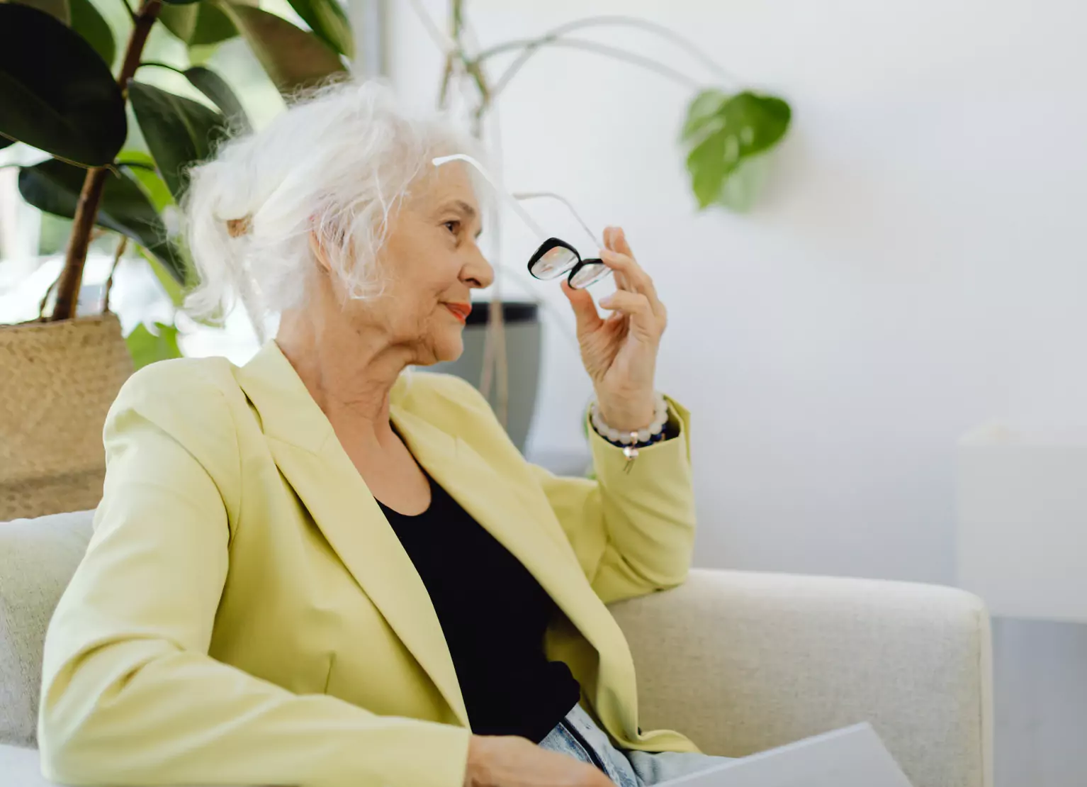 an older woman sitting in a chair 