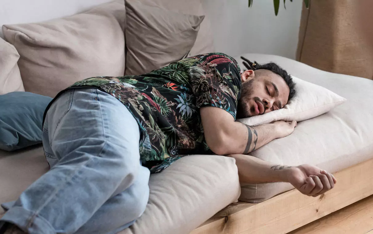 a person sleeping on a sofa