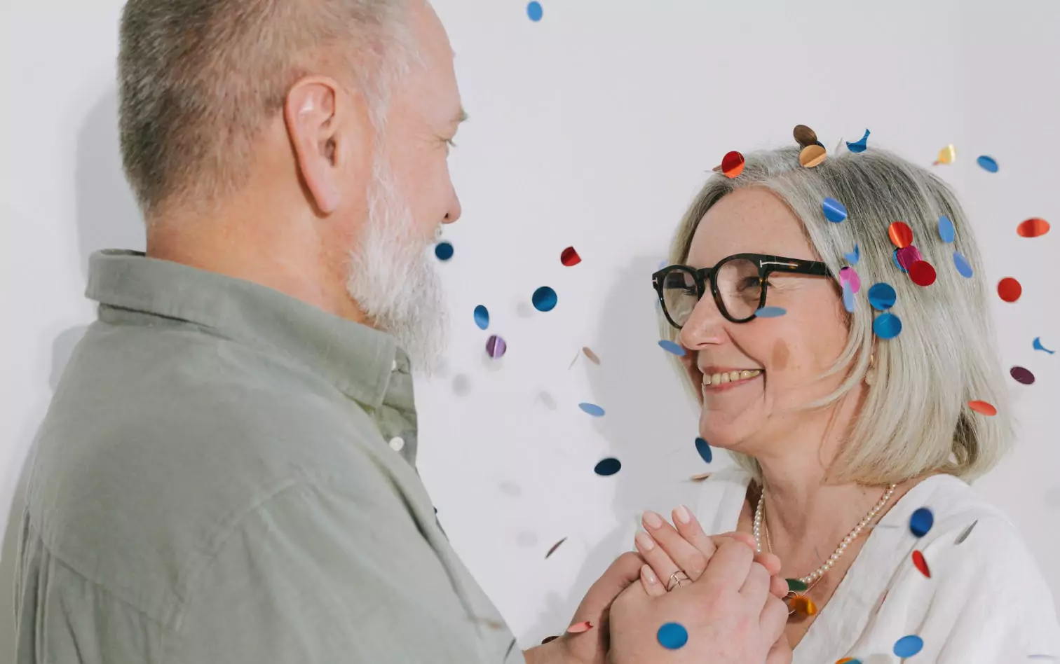 two older people smiling at each other