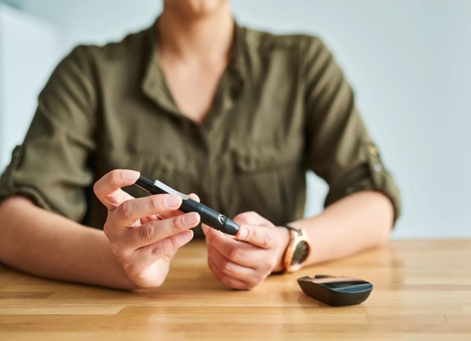 a person using finger prick method to test glucose levels