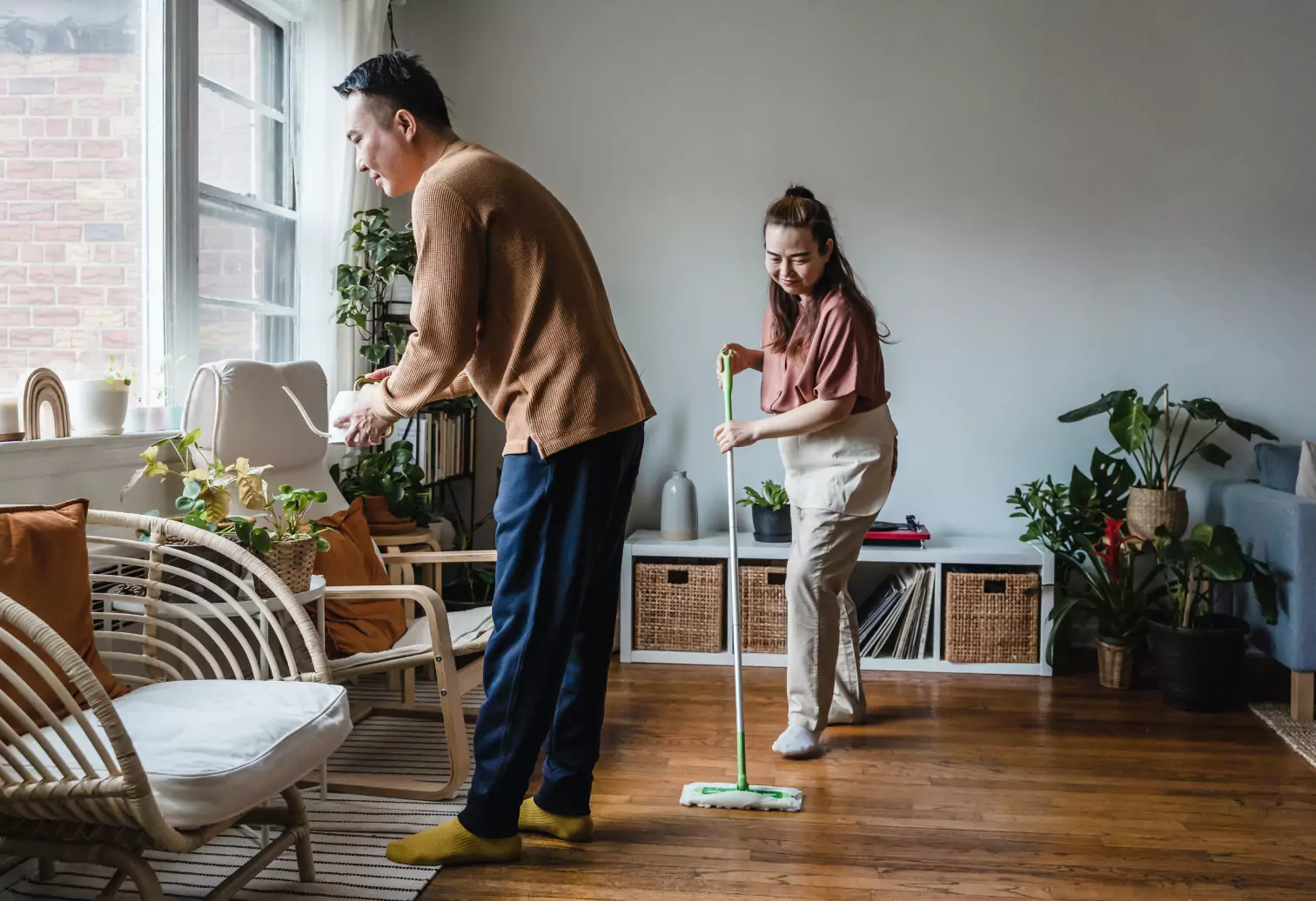 a couple of people cleaning a room