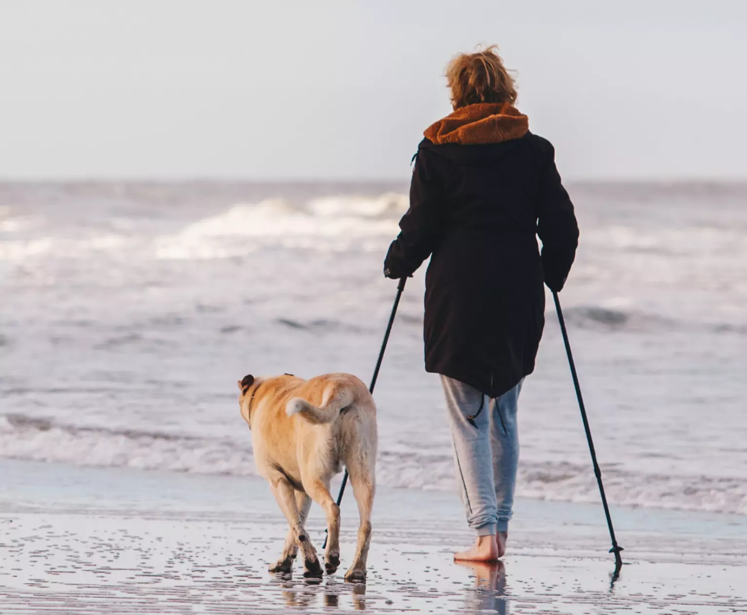 a person nordic walking on the beach