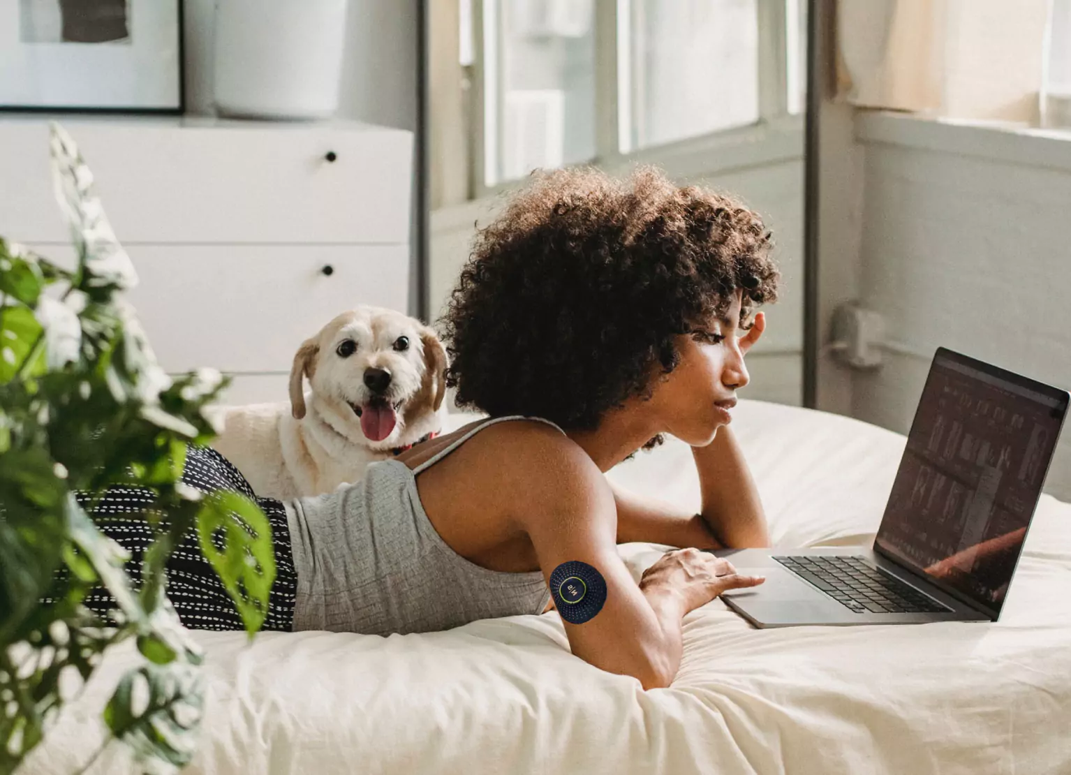 a girl laying in bed with a dog