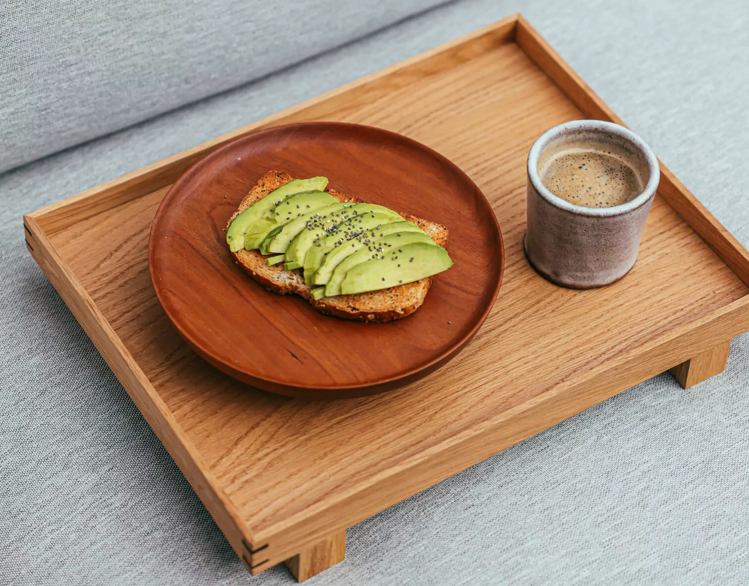 a plate of avocado toast and a coffee