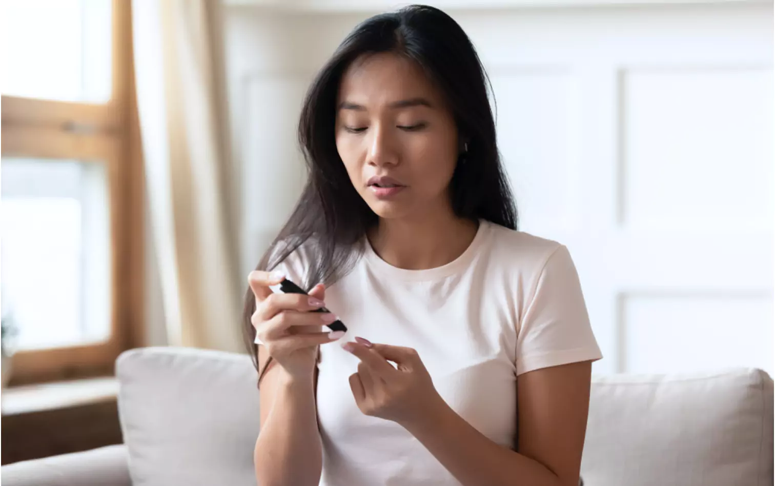 a person using finger prick method to test their glucose level