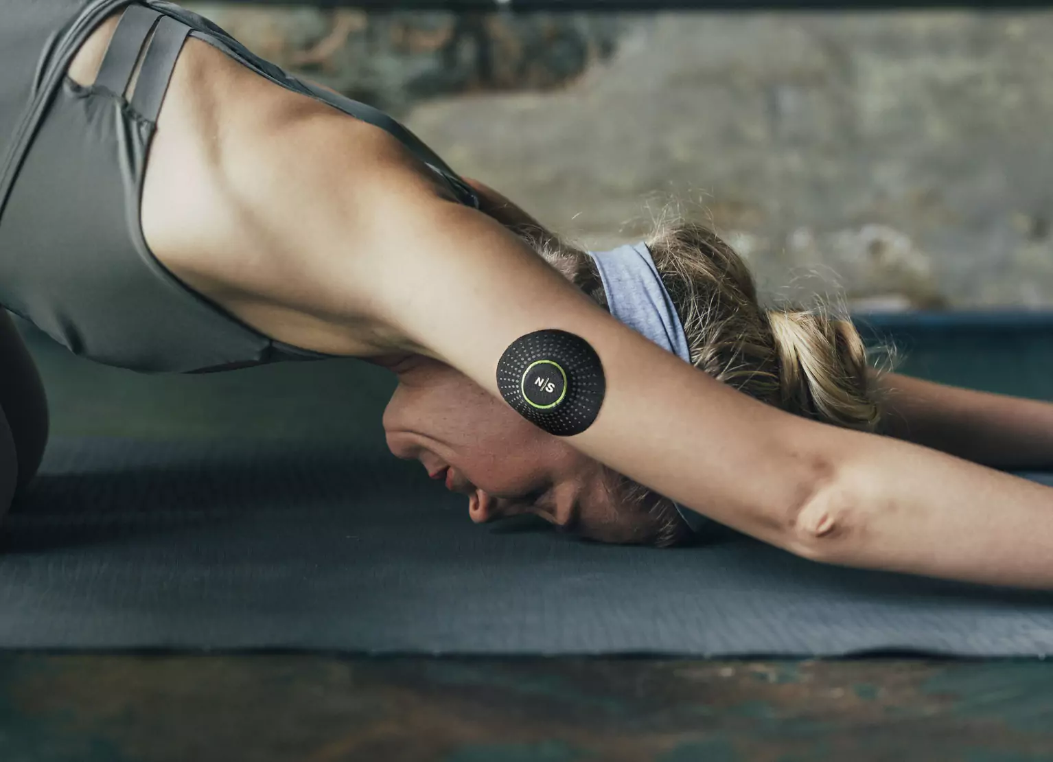 a person wearing Nutrisense CGM and stretching