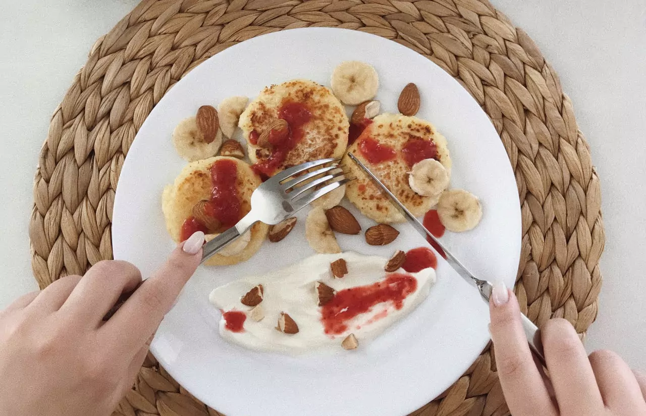 pancakes, bananas, almonds and yogurt on a plate