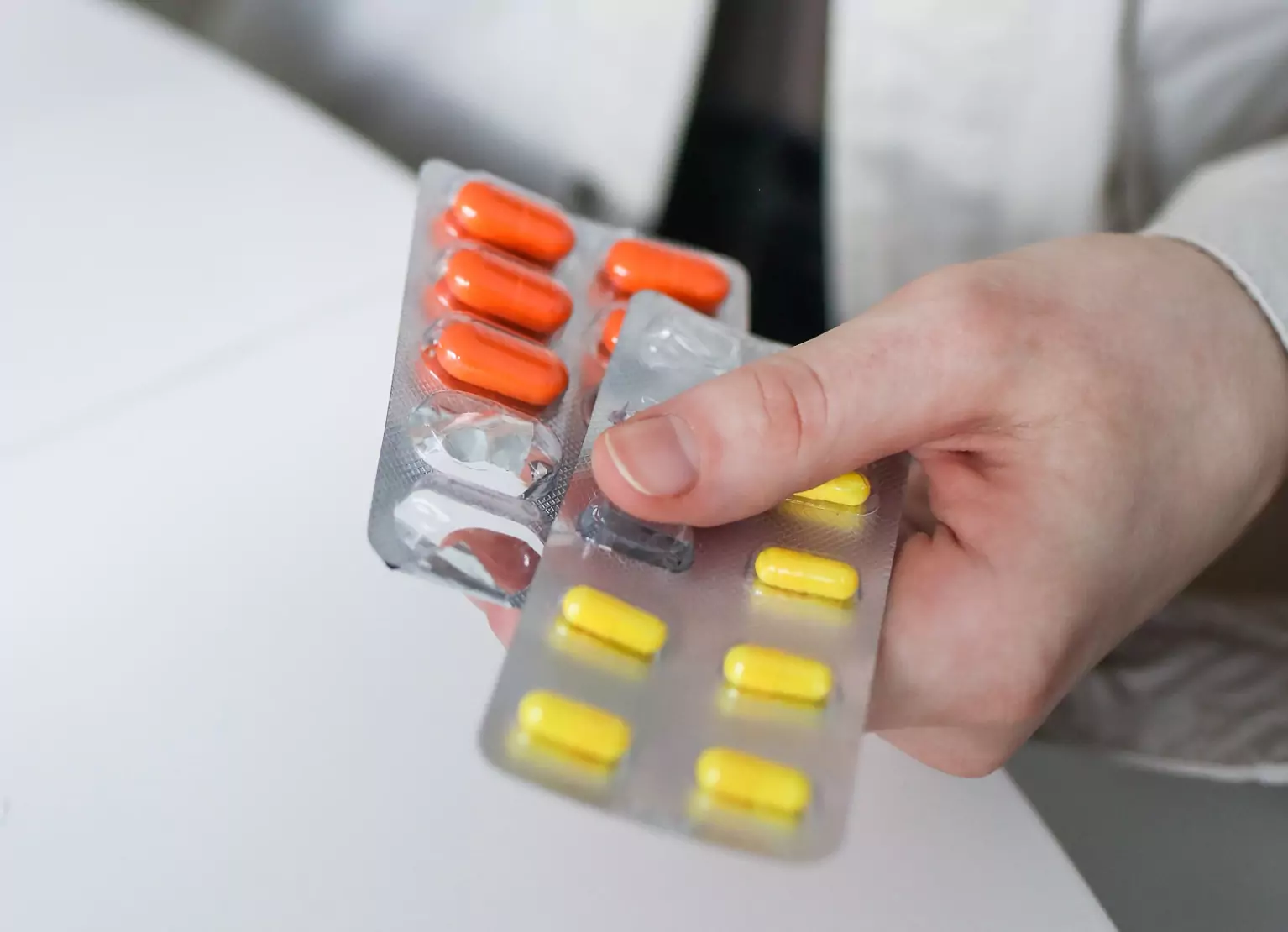 Person holding two packs of probiotic supplements