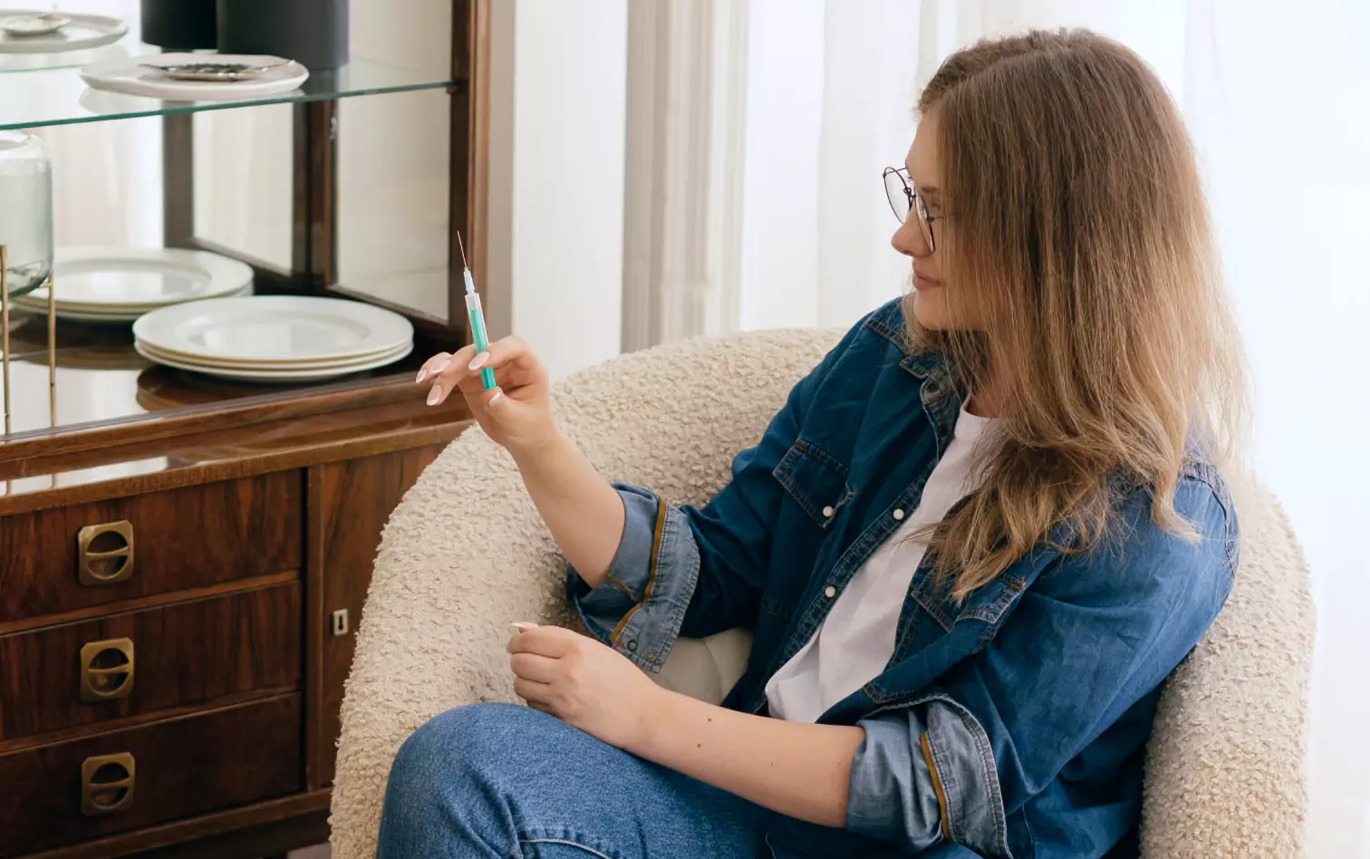 a person preparing to inject the insulin