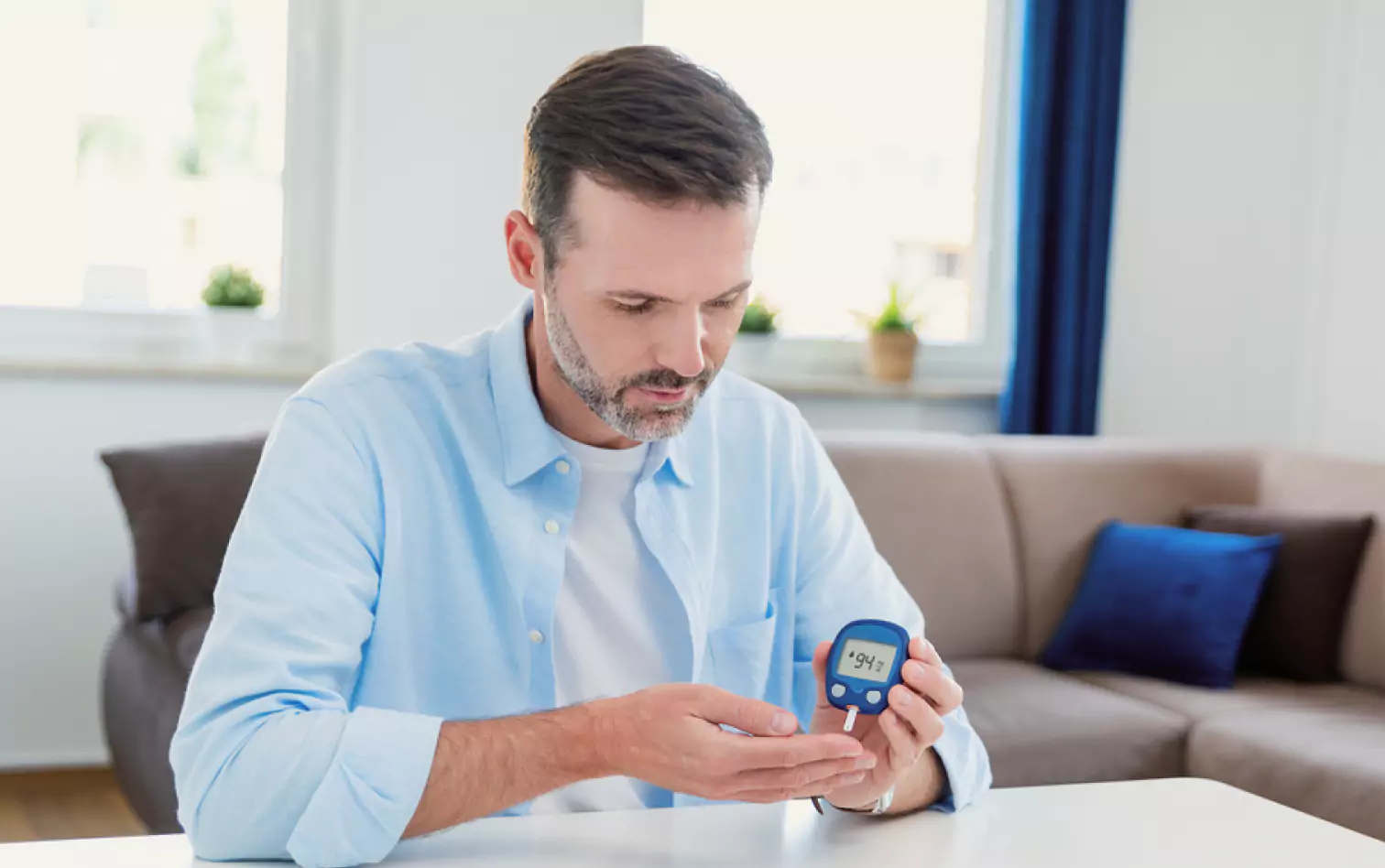 a person using finger prick method to test their glucose level