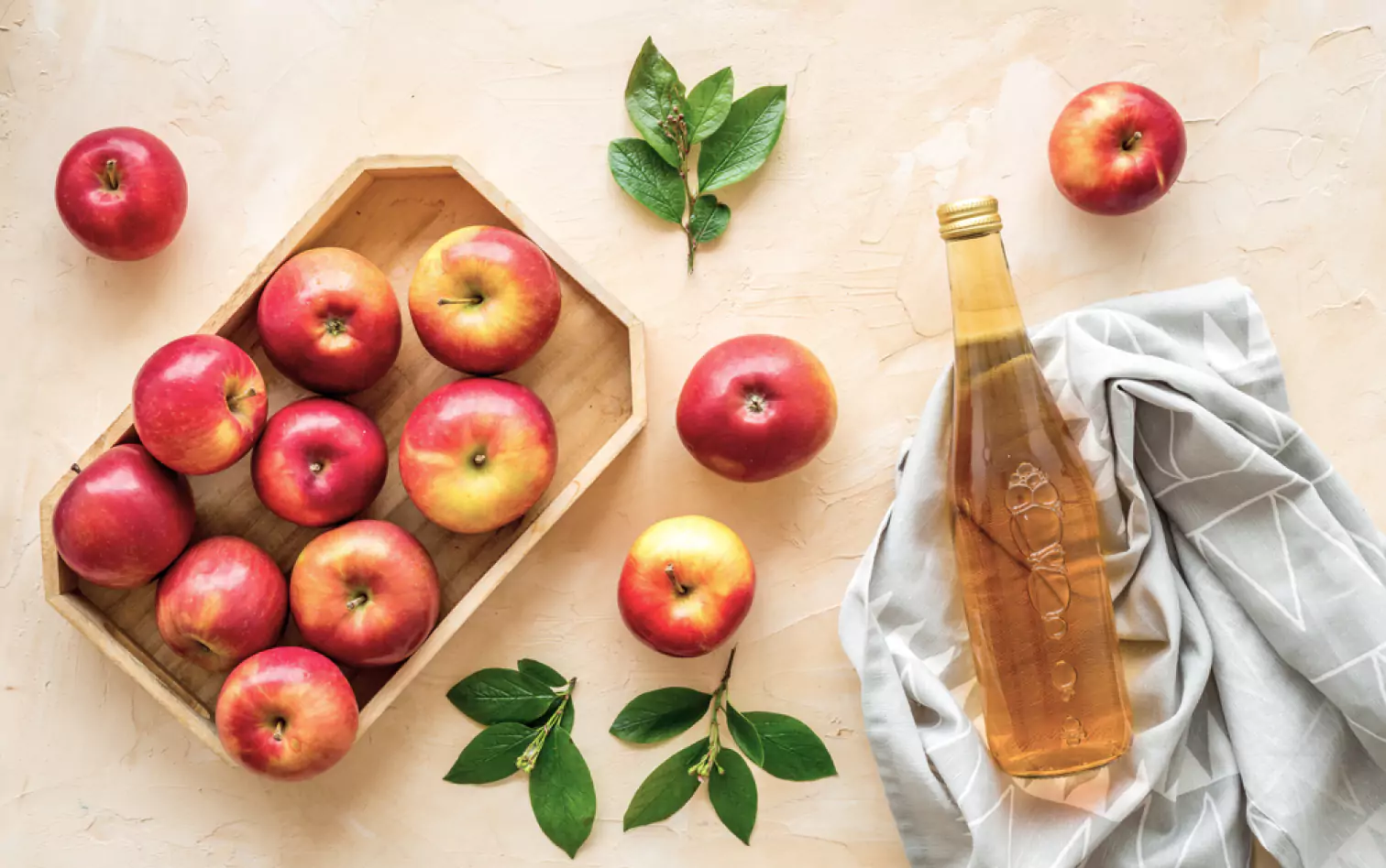 a bottle of vinegar and apples