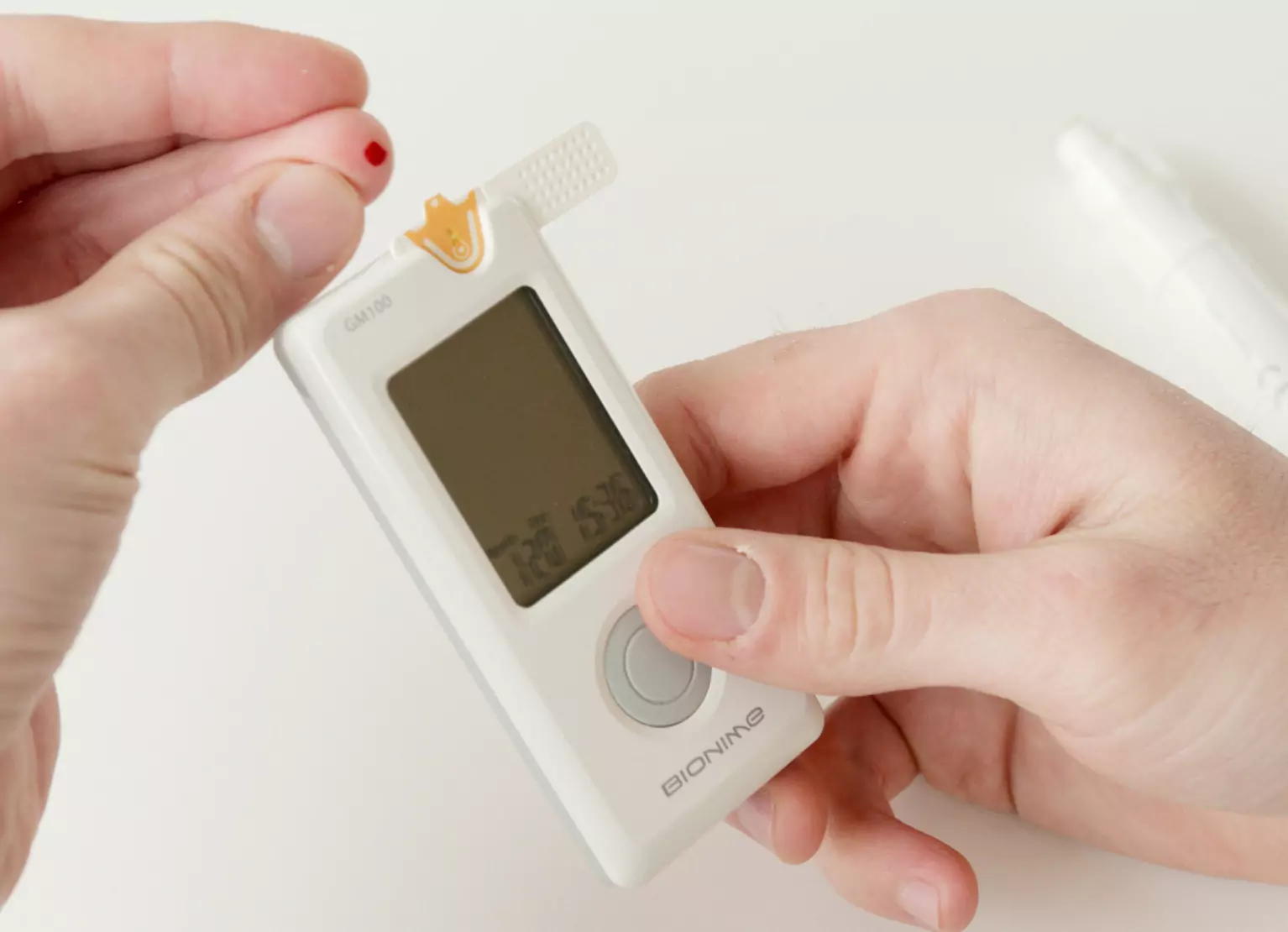 Person pricking their finger for blood glucose testing