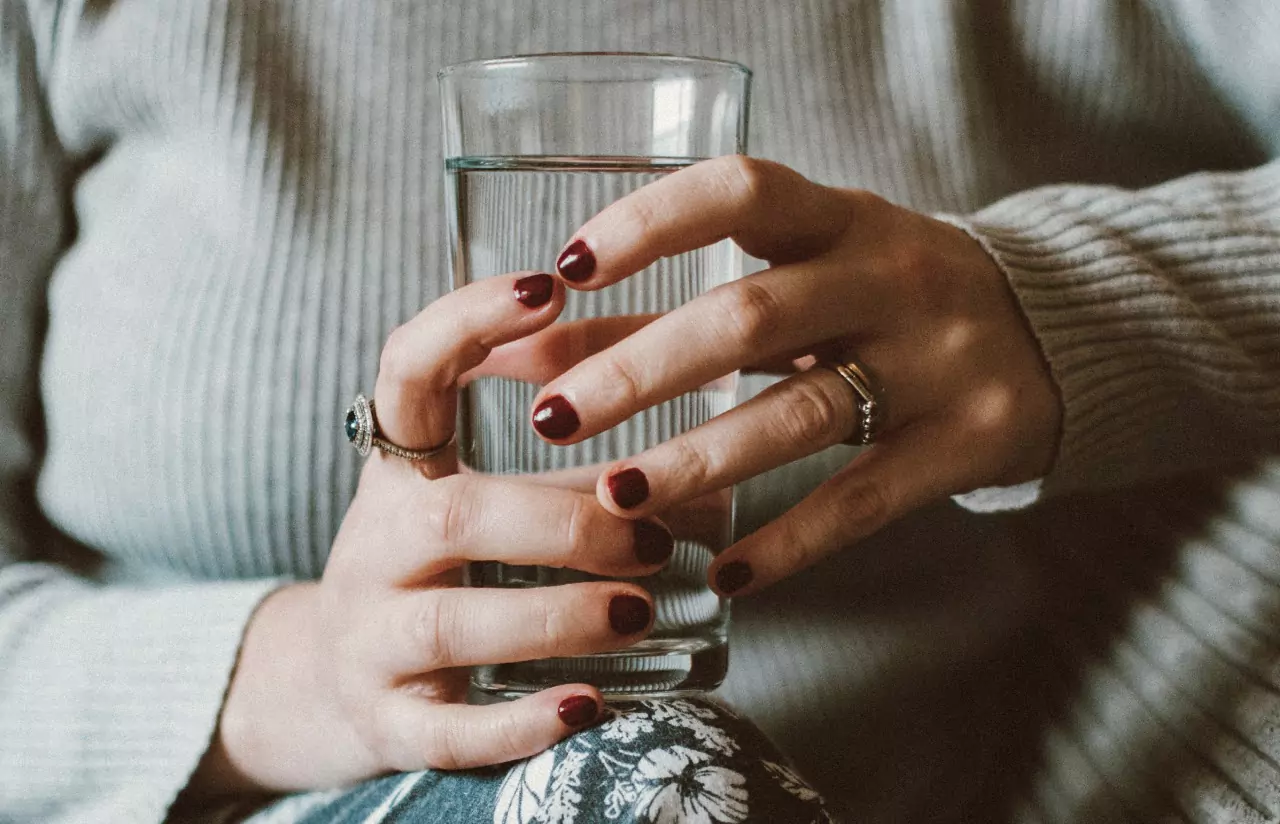 a person holding a glass of water