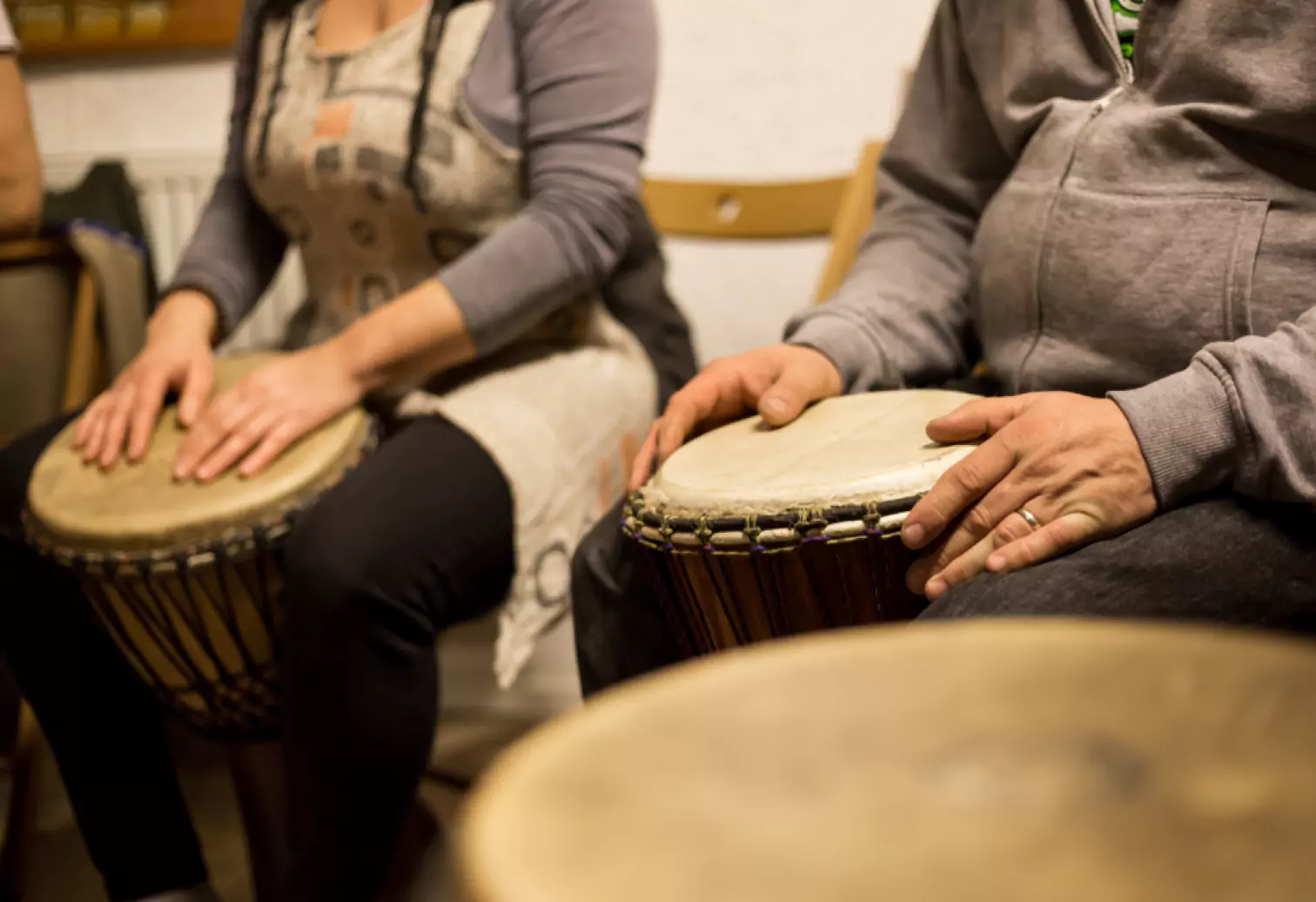 two people playing bongo