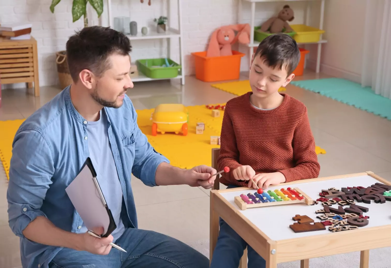 a music teacher instructing a boy