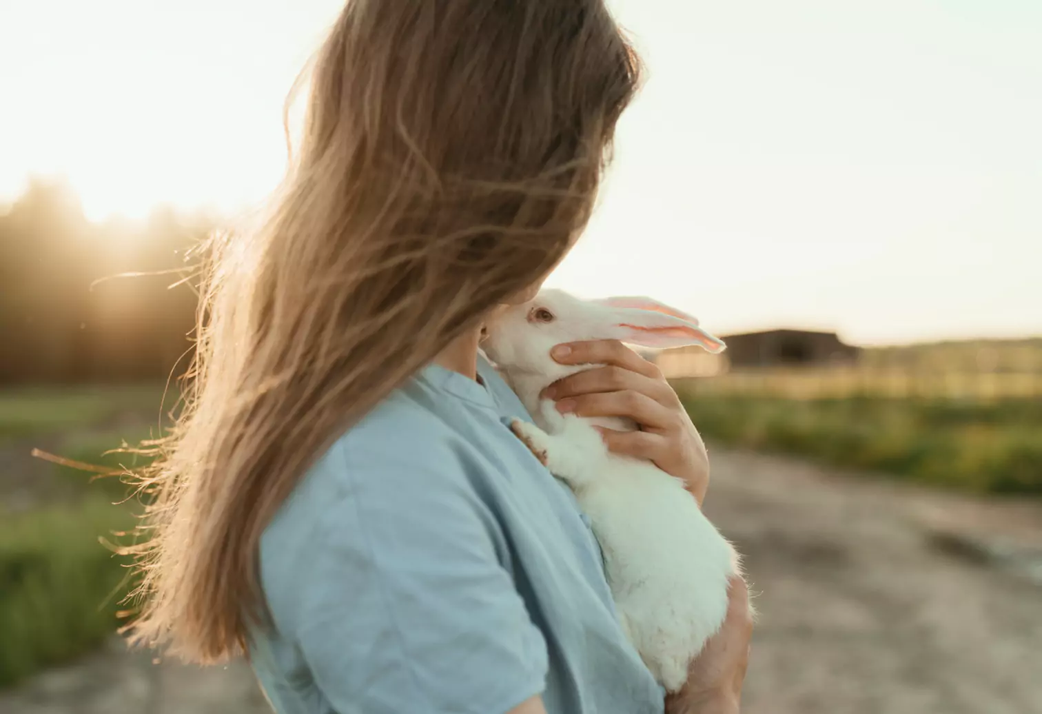 a woman holding a rabbit 