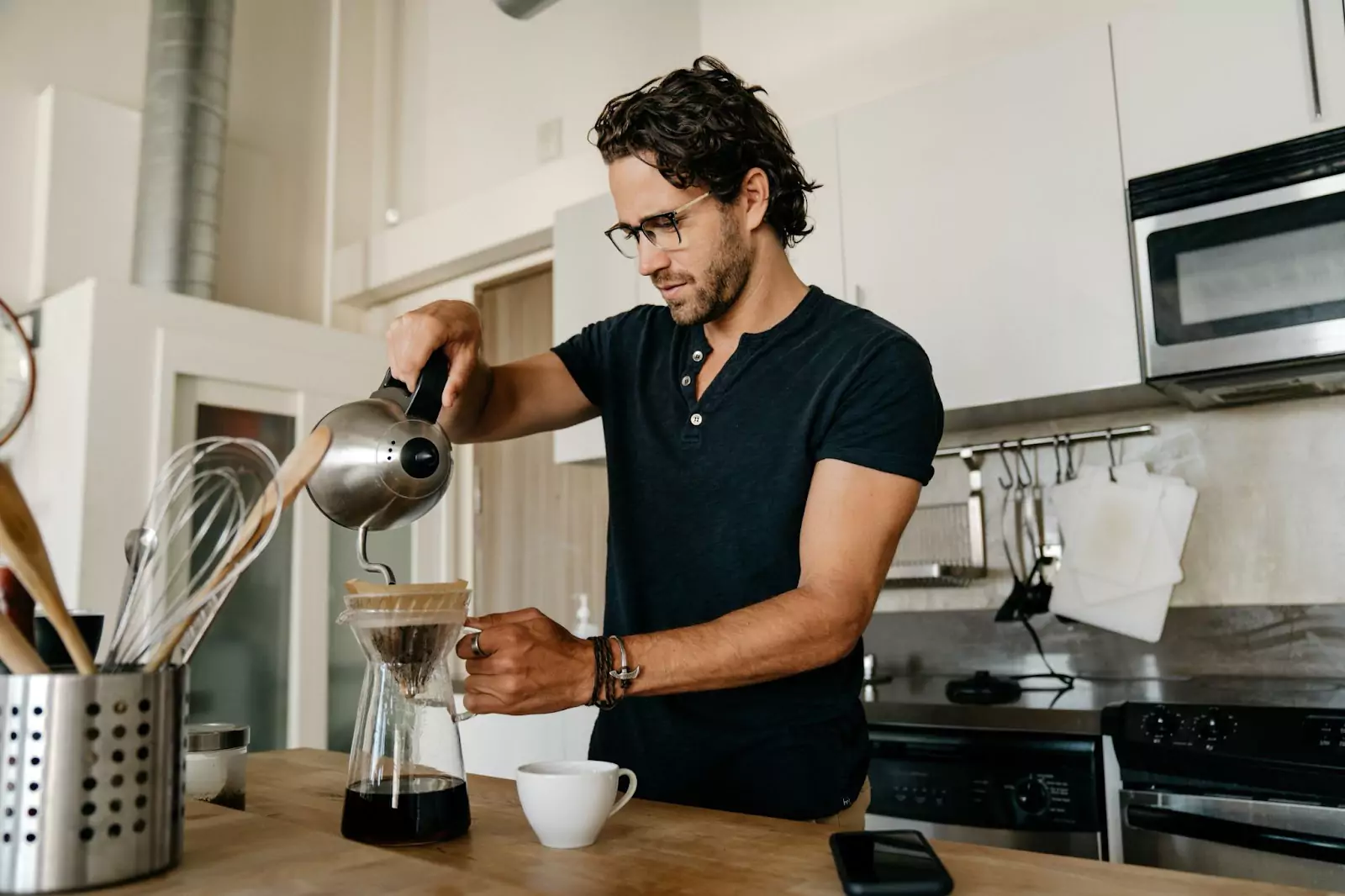 a person making coffee using chemex 