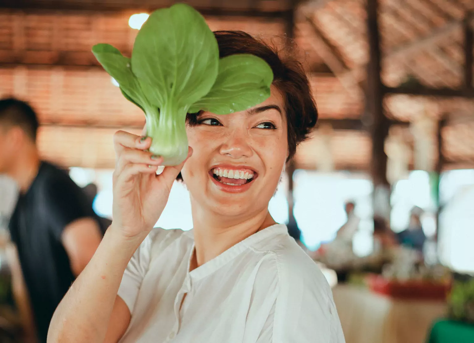 Woman holding up organic leafy greens