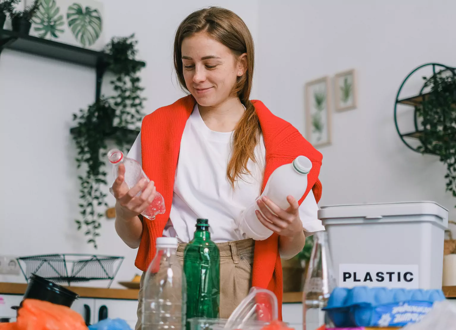 Woman throwing away plastic bottles