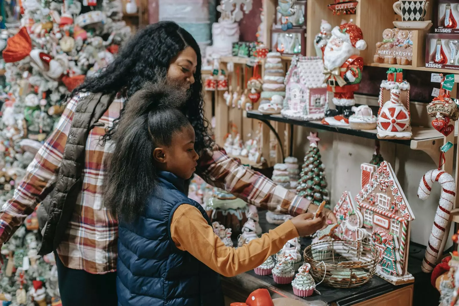 an adult and a kid picking Christmas sweets 