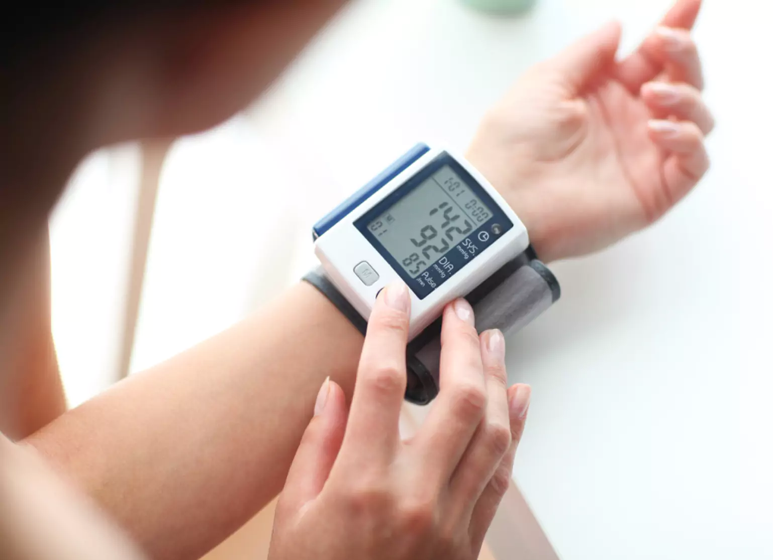 Person measuring their blood pressure