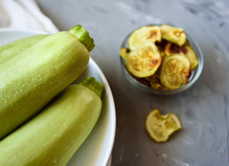 a few whole zucchinis and zucchini chips