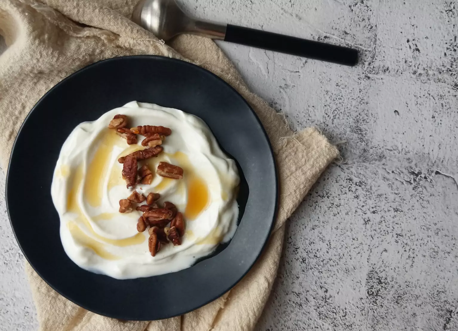 a plate of greek yogurt topped with nuts