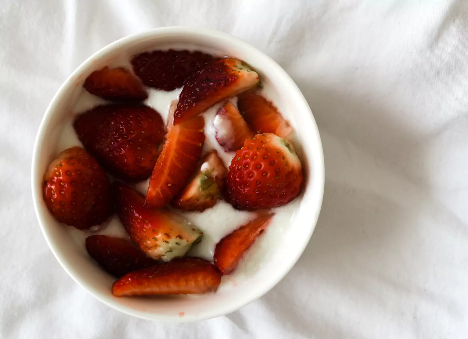 a bowl of yogurt with strawberries