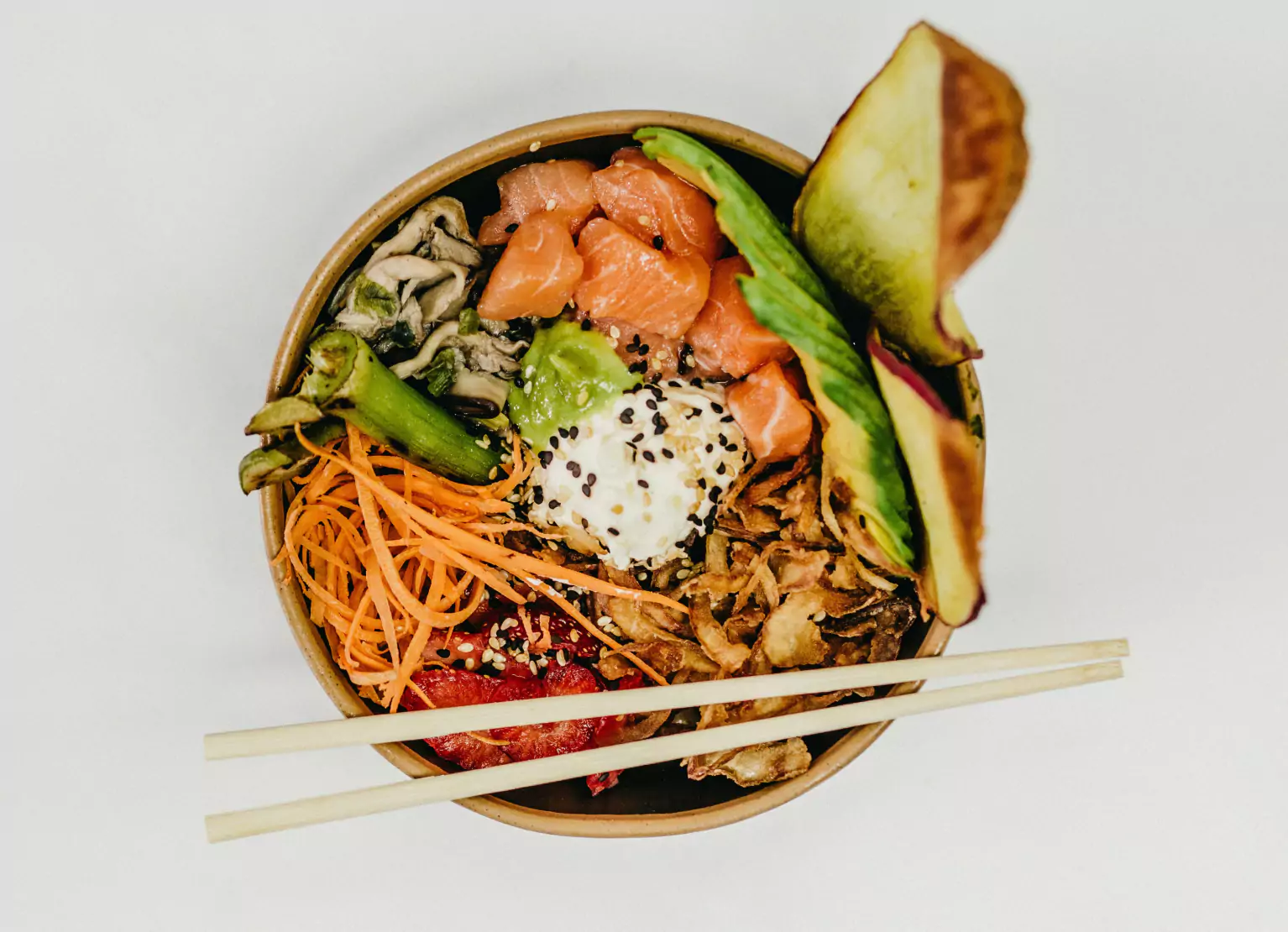 a noodle bowl with salmon and veggies