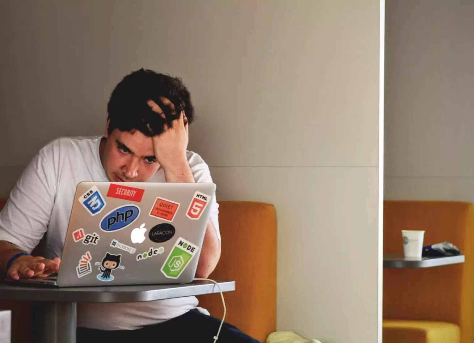 a person sitting at a table, looking stressed 