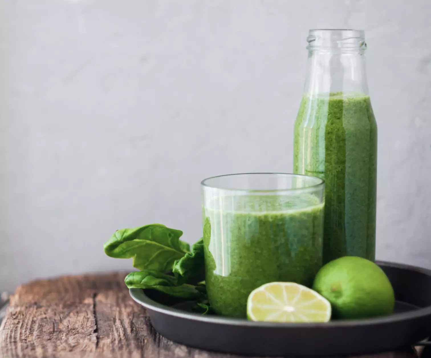 a plate with celery juice in a container