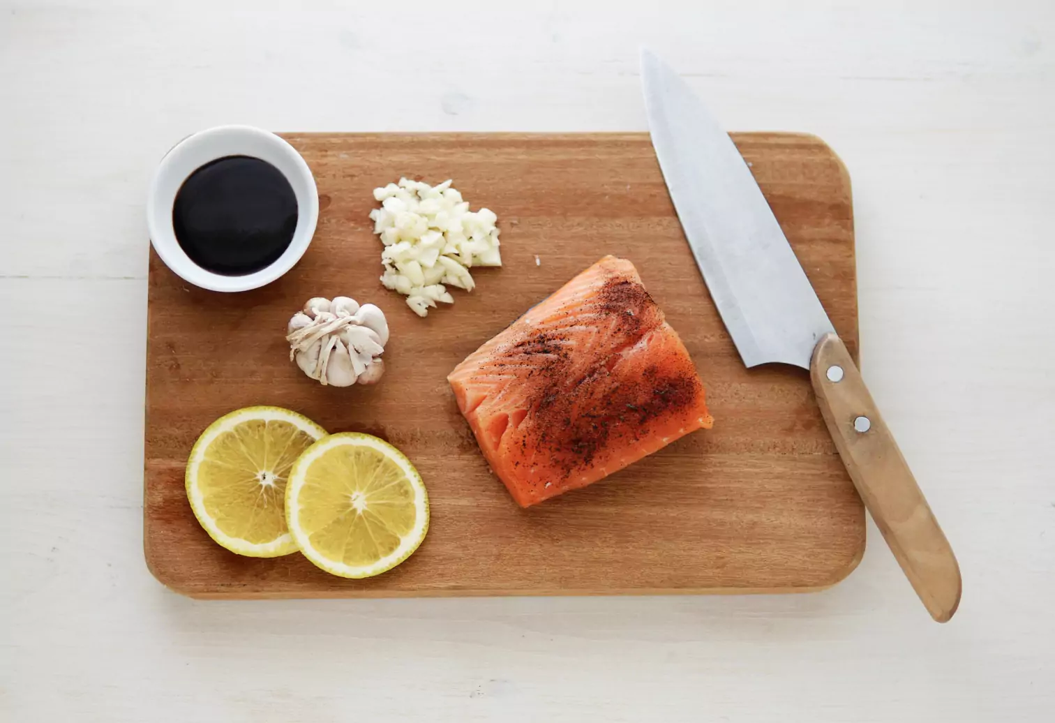 cutting board with salmon andveggies