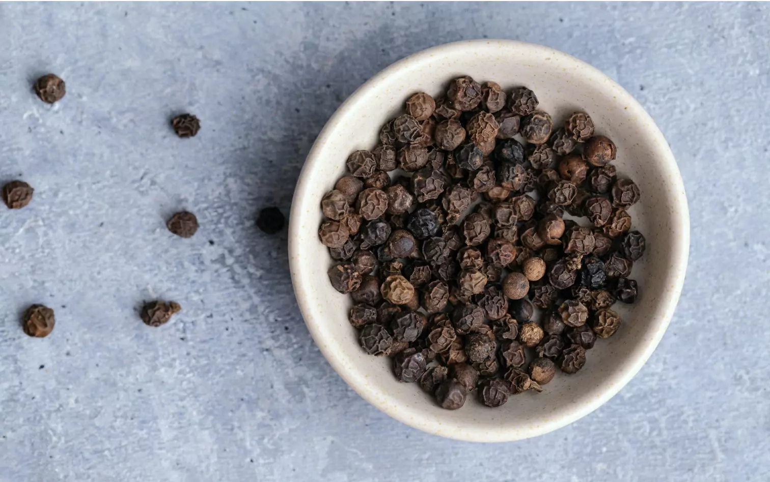 A bowl of black peppercorns