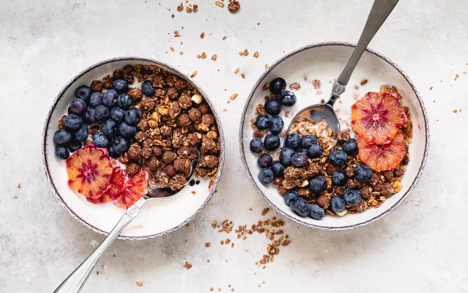 two bowls of Cereal, blueberries and milk 