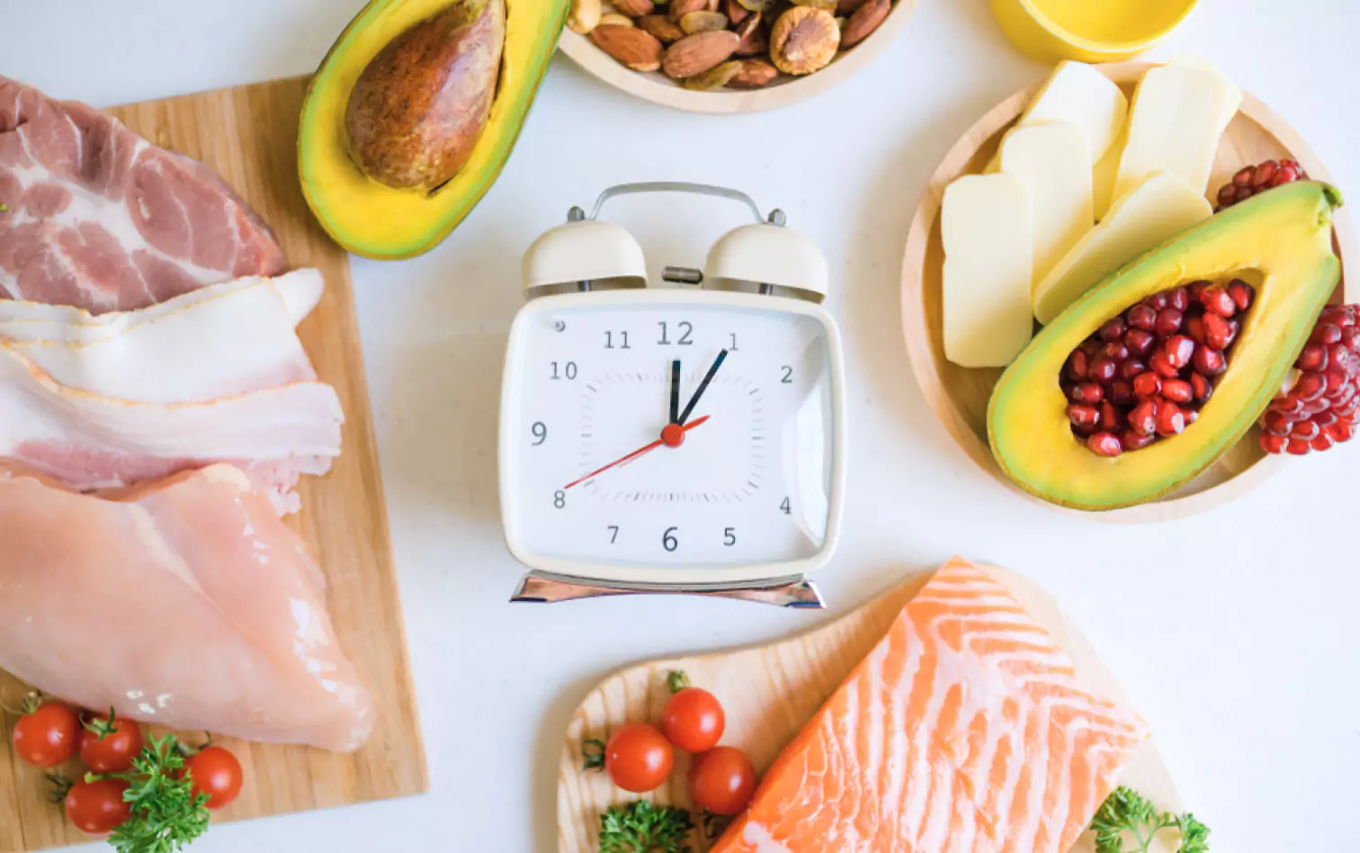 a clock, cheese, meat, fish and an avocado 