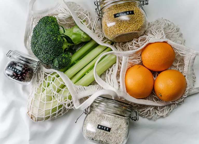 grains, fruits, and veggies in a shopping bag