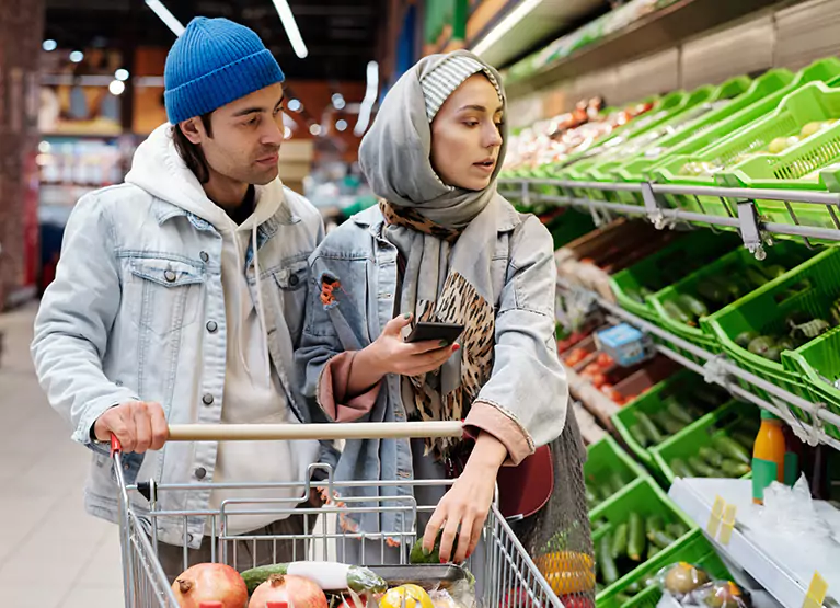 a couple picking out produce at the grocery store