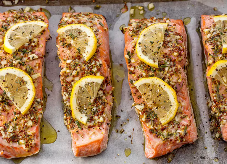 broiled salmon with lemon on a tray