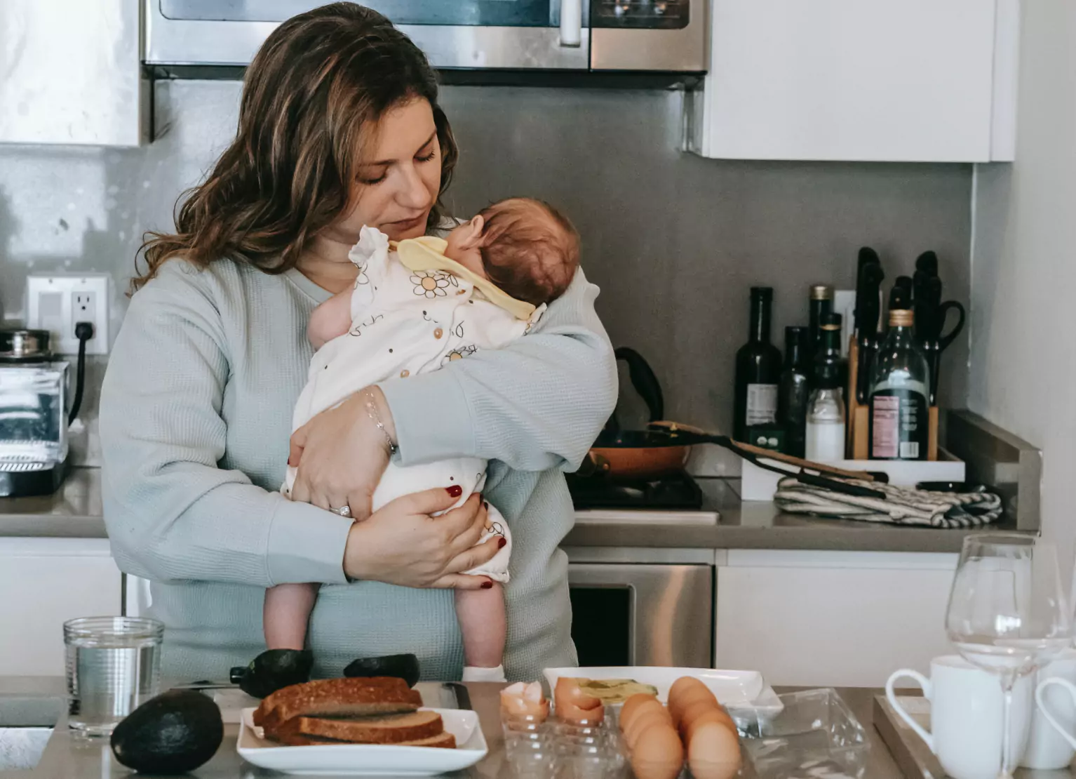 Mom holding baby in kitchen