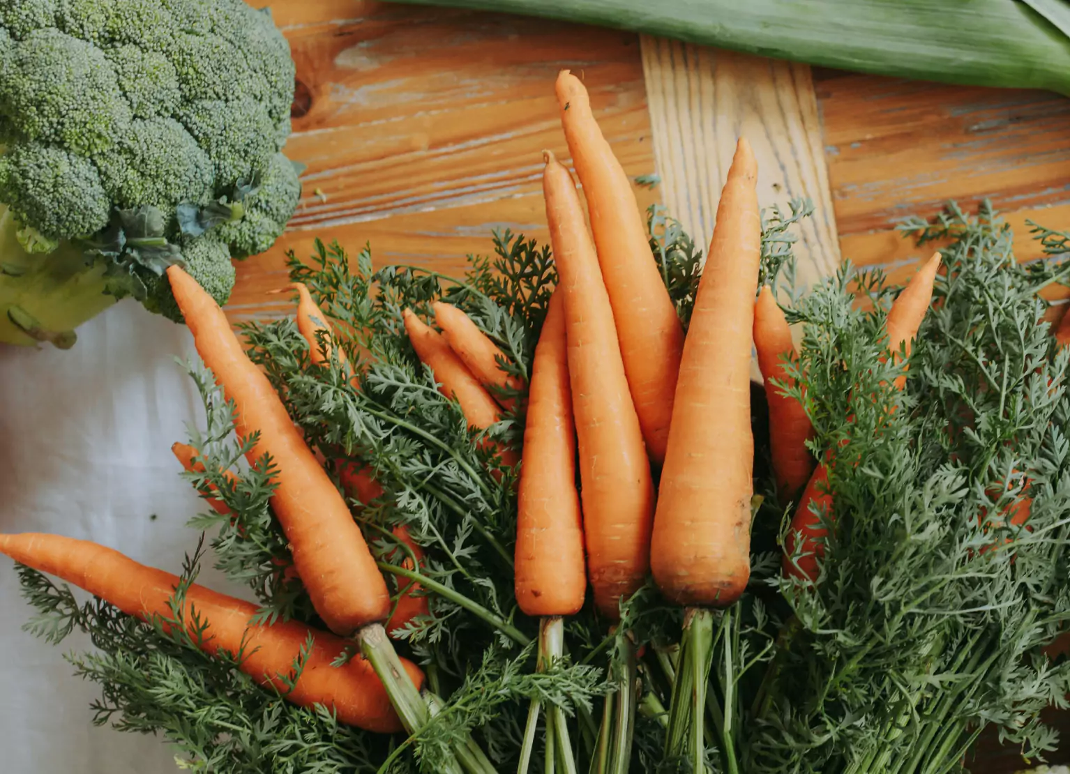 Tabletop with carrots and broccoli