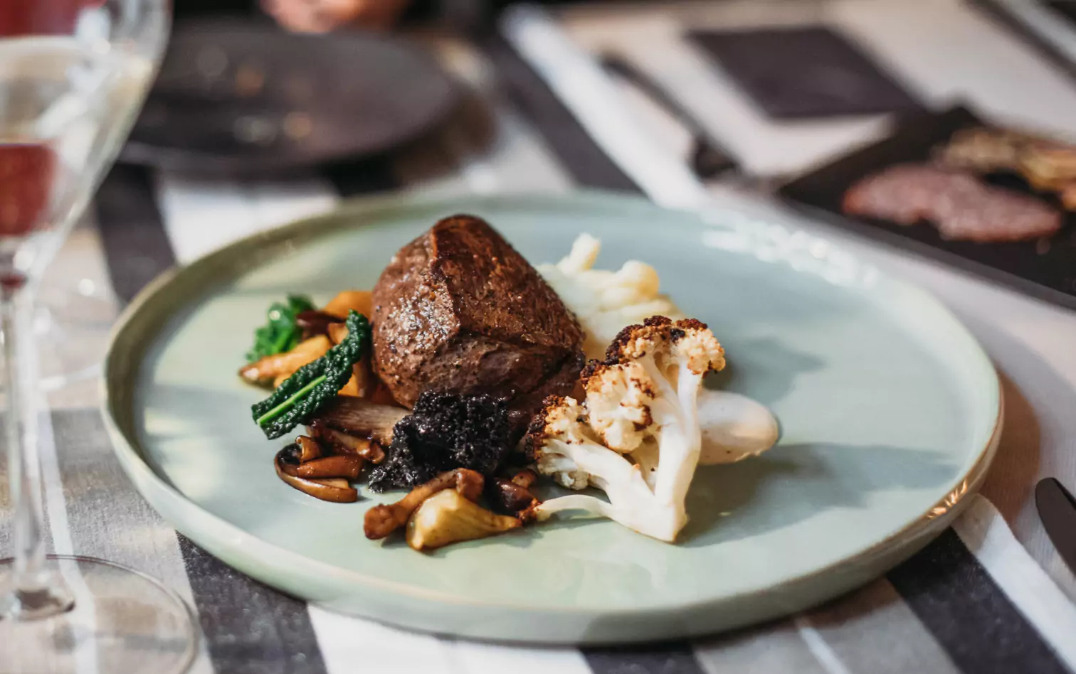 a plate of steak, cauliflower