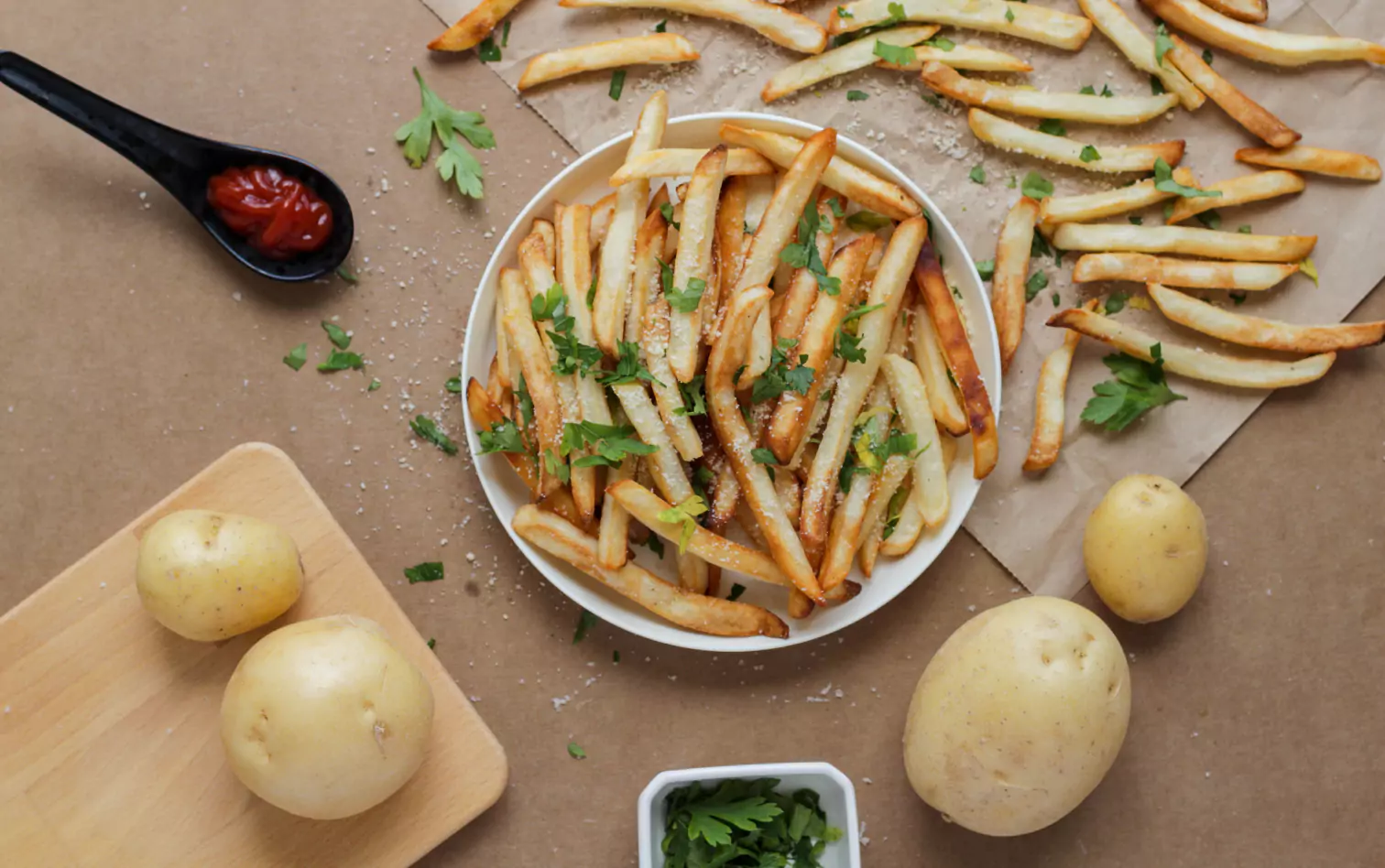 a plate of fries and a soon of sauce 