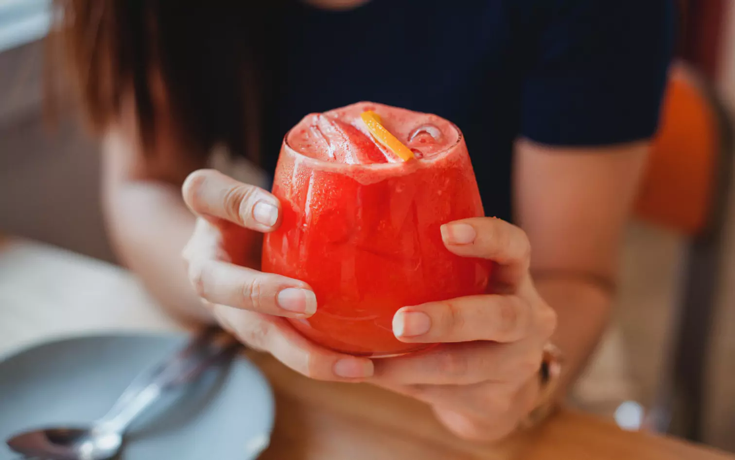 a person holding a sugary drink