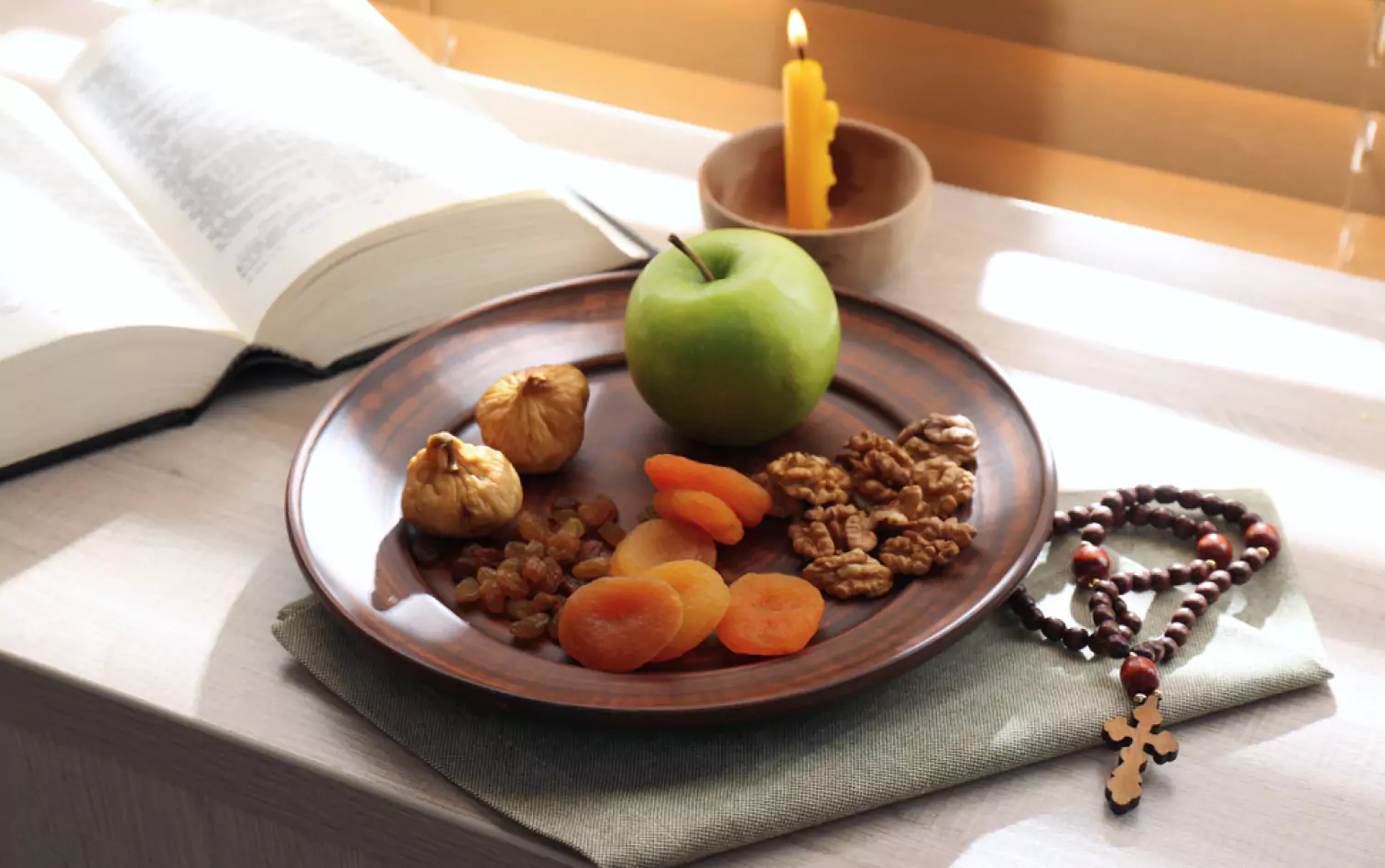 a plate of an apple walnuts, dried apricots, raisins