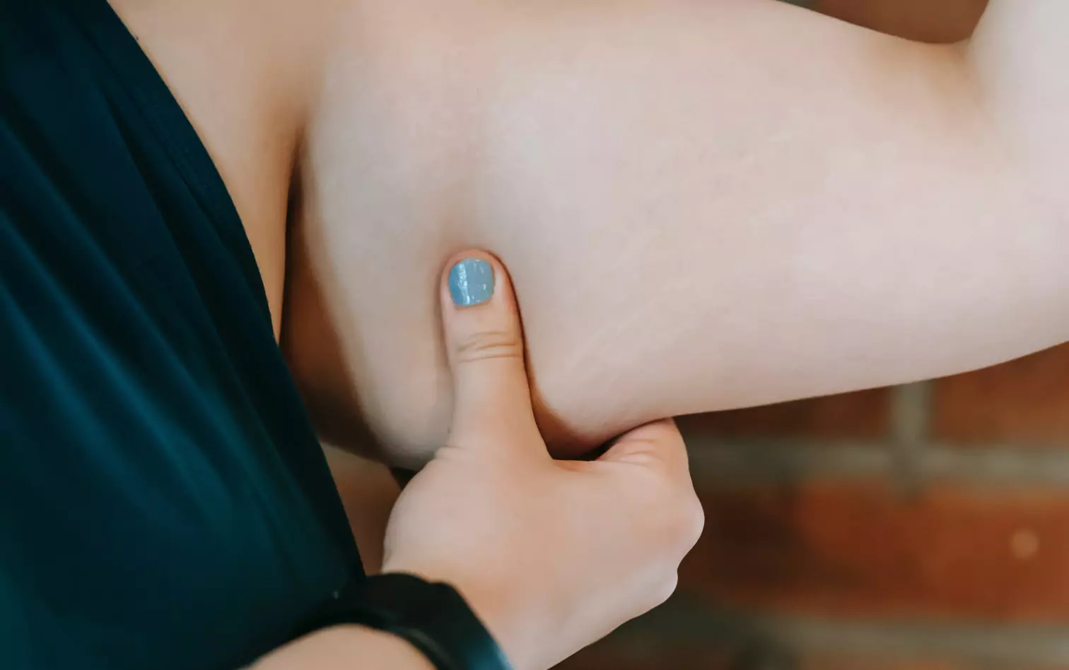 a person squeezing their upper arm