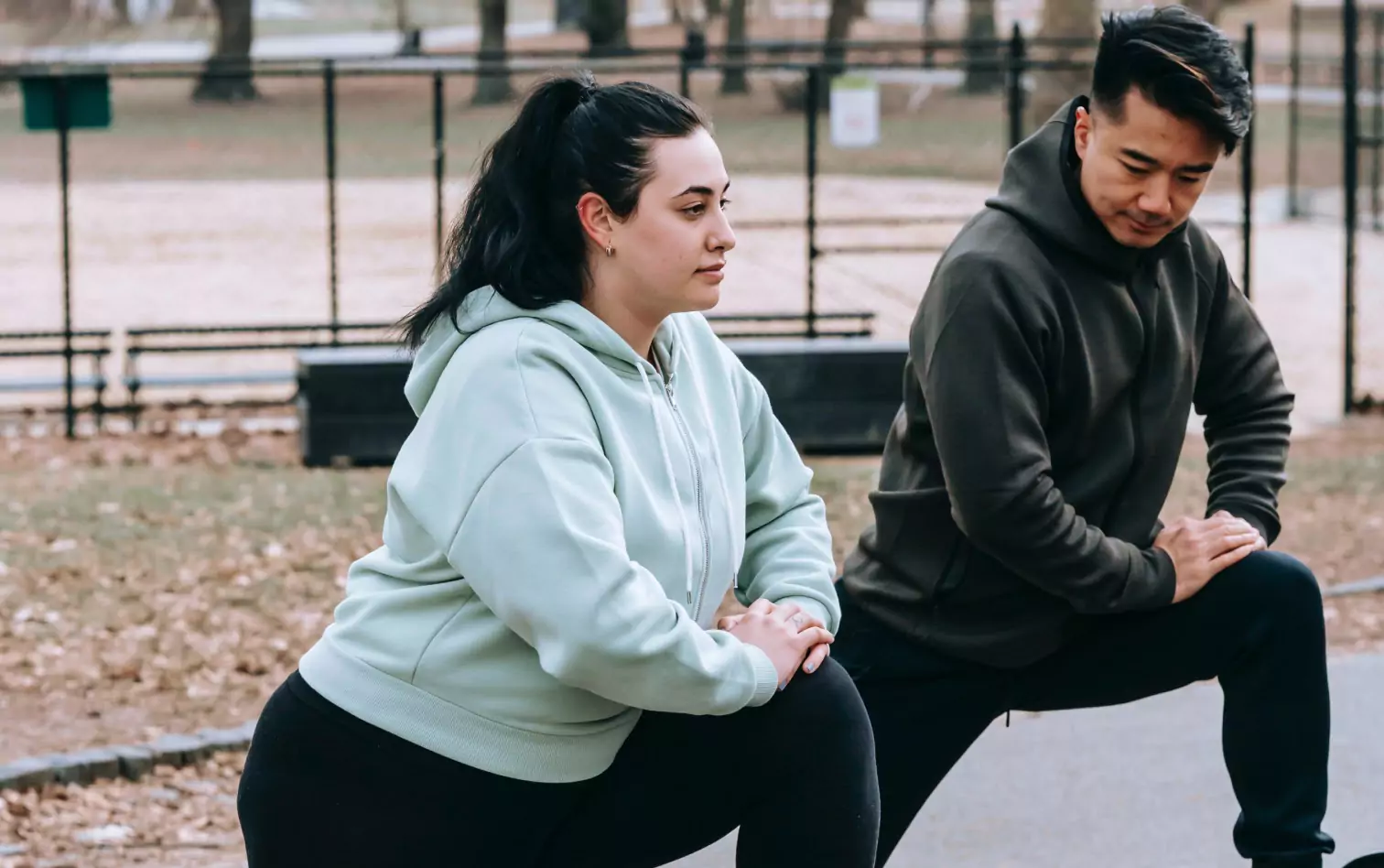 two person stretching outdoors 