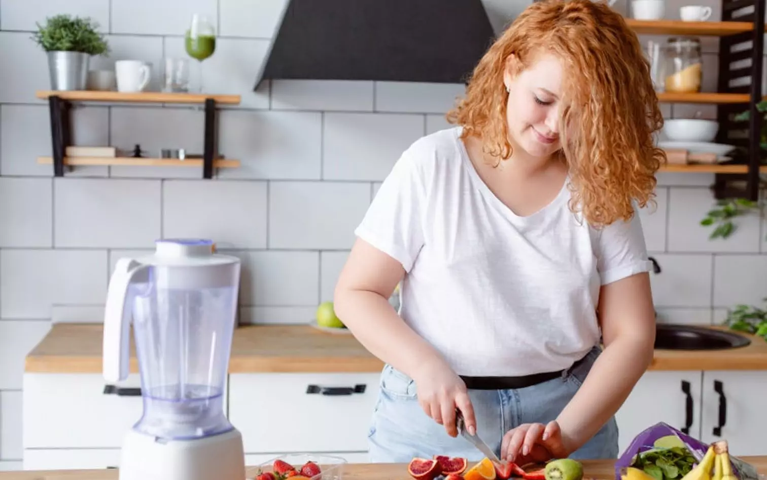 a person cutting fruits in the kitchen 